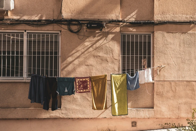 washing on the line, hanging from a balcony over a window