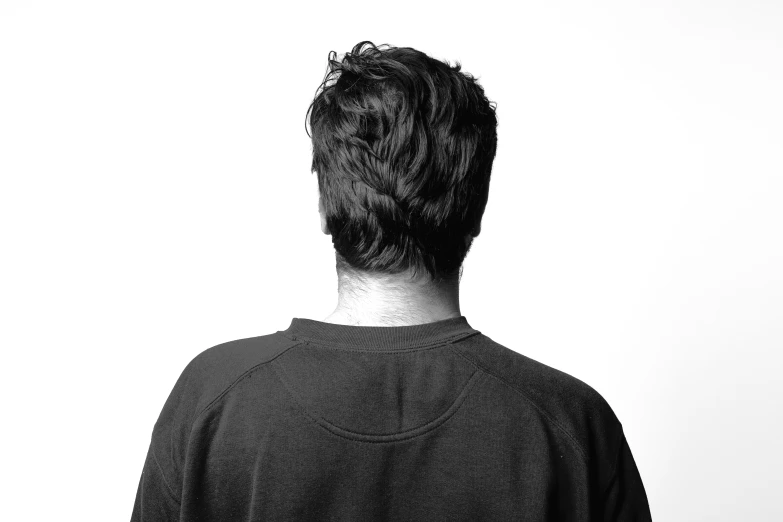 the back of a man's head against a white wall