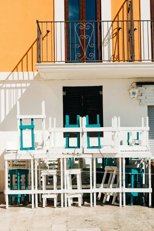 many blue chairs and a table on the sand