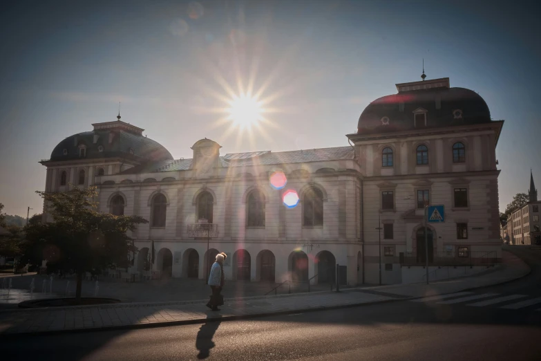 the sun shines brightly over the top of a large stone building