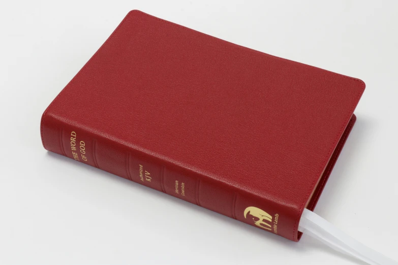 a red book sitting on top of a white table