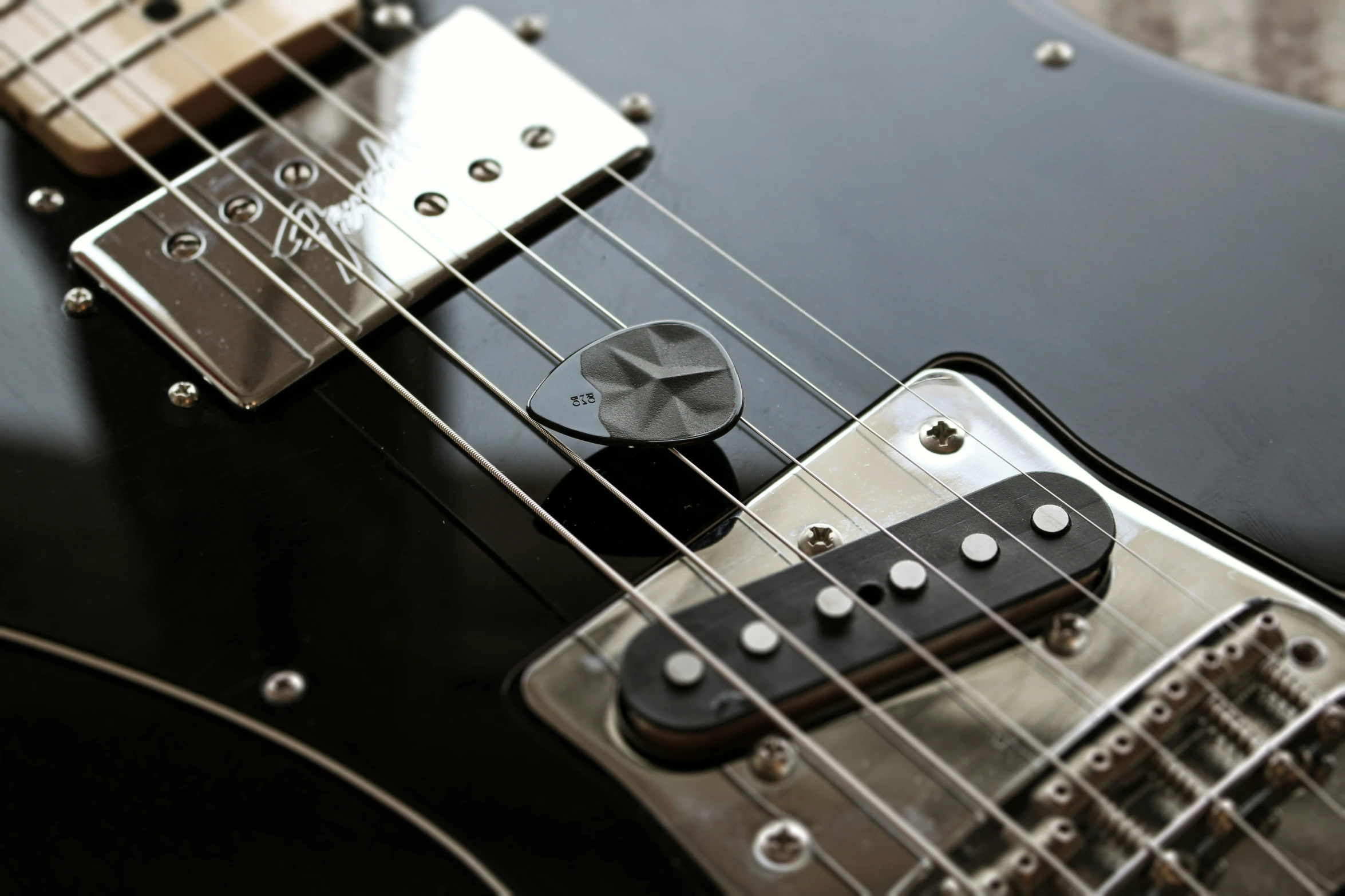 close up image of an electric guitar with the pickup on highlighted