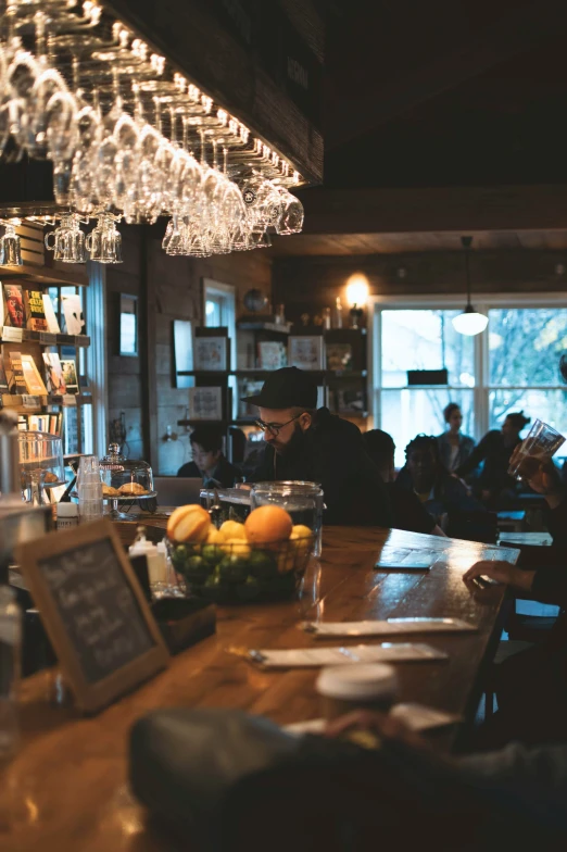 a person sitting at a counter with a bowl of fruit