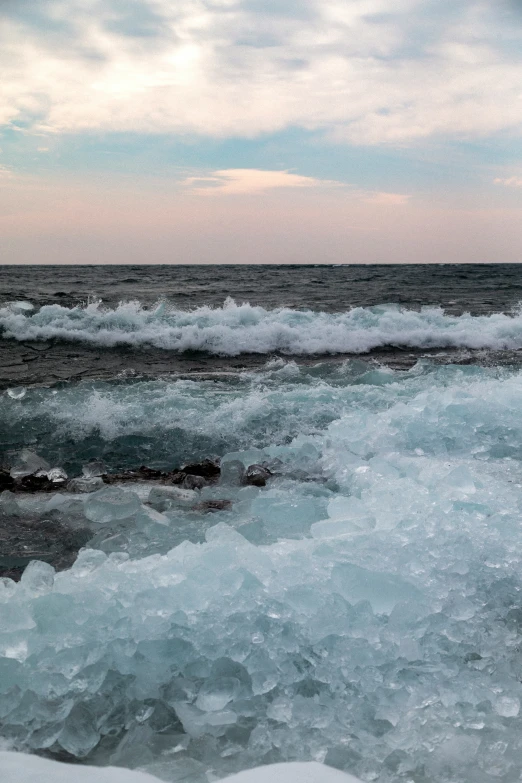 waves come in as the sun rises on the ocean