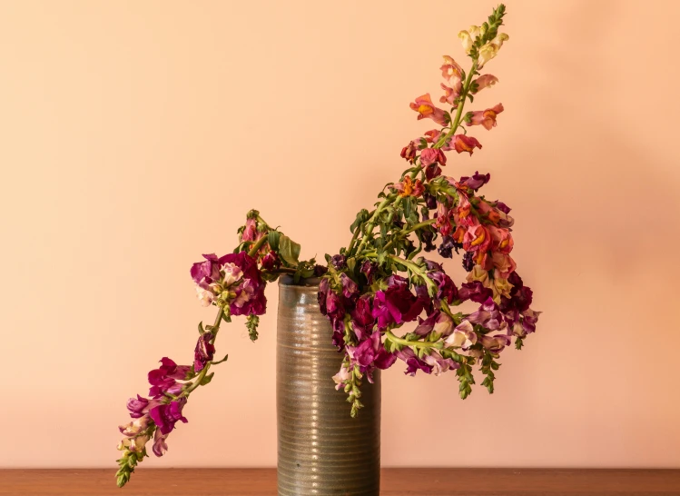 an antique metal vase holding some pretty flowers