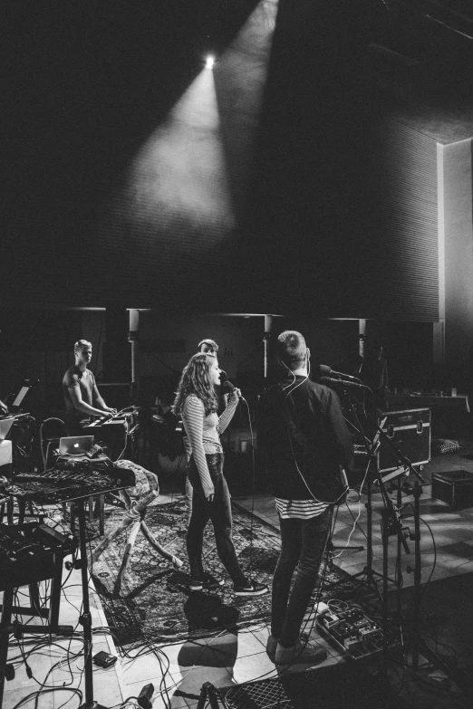 black and white pograph of band on stage with lighting