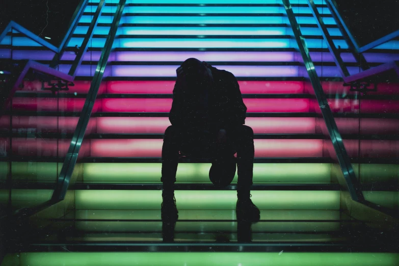 there is a person sitting on a colorful staircase