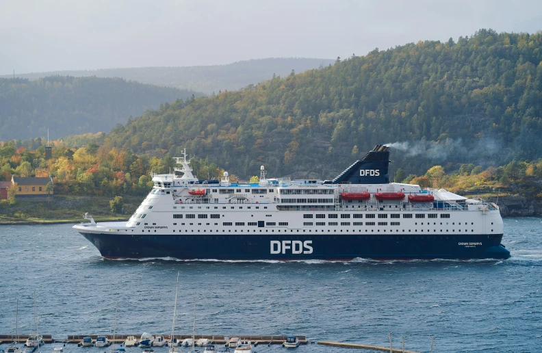 a large white and blue ship traveling in the water