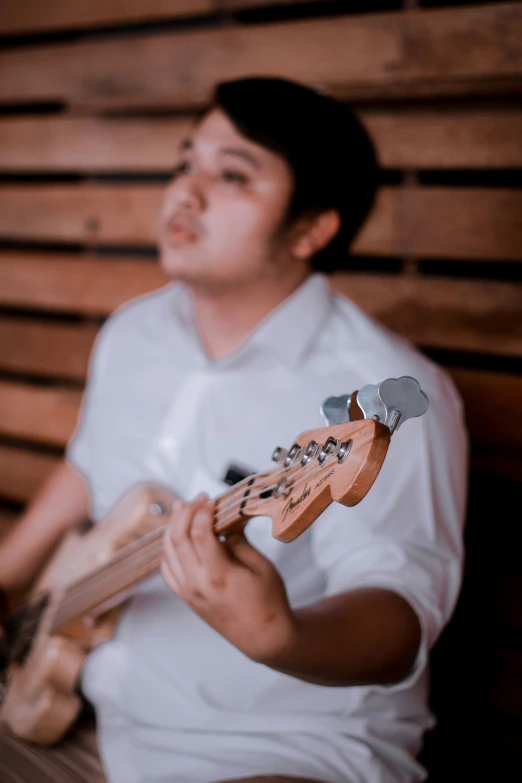 a young man is playing a guitar in a studio