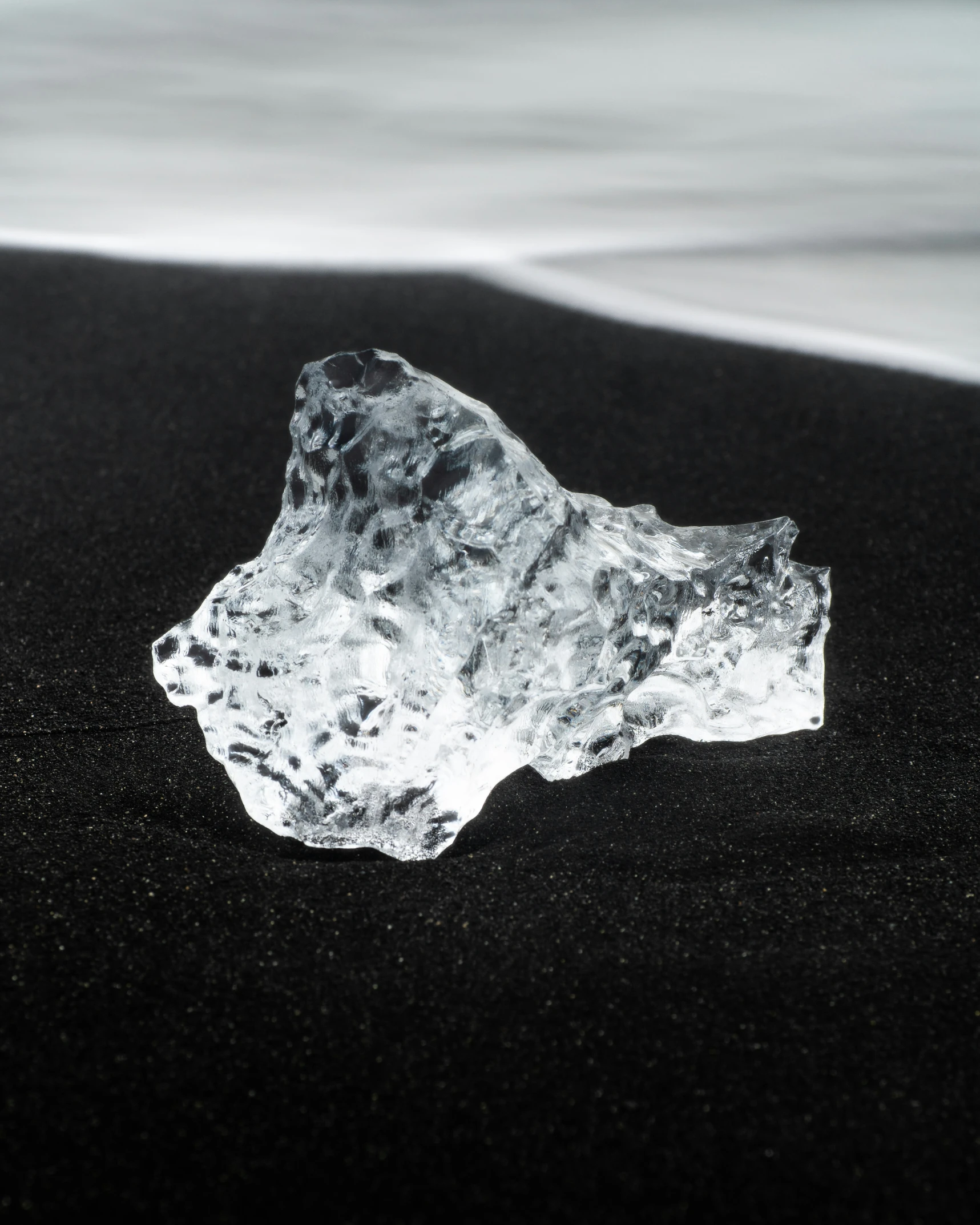 an ice piece lying in the black sand