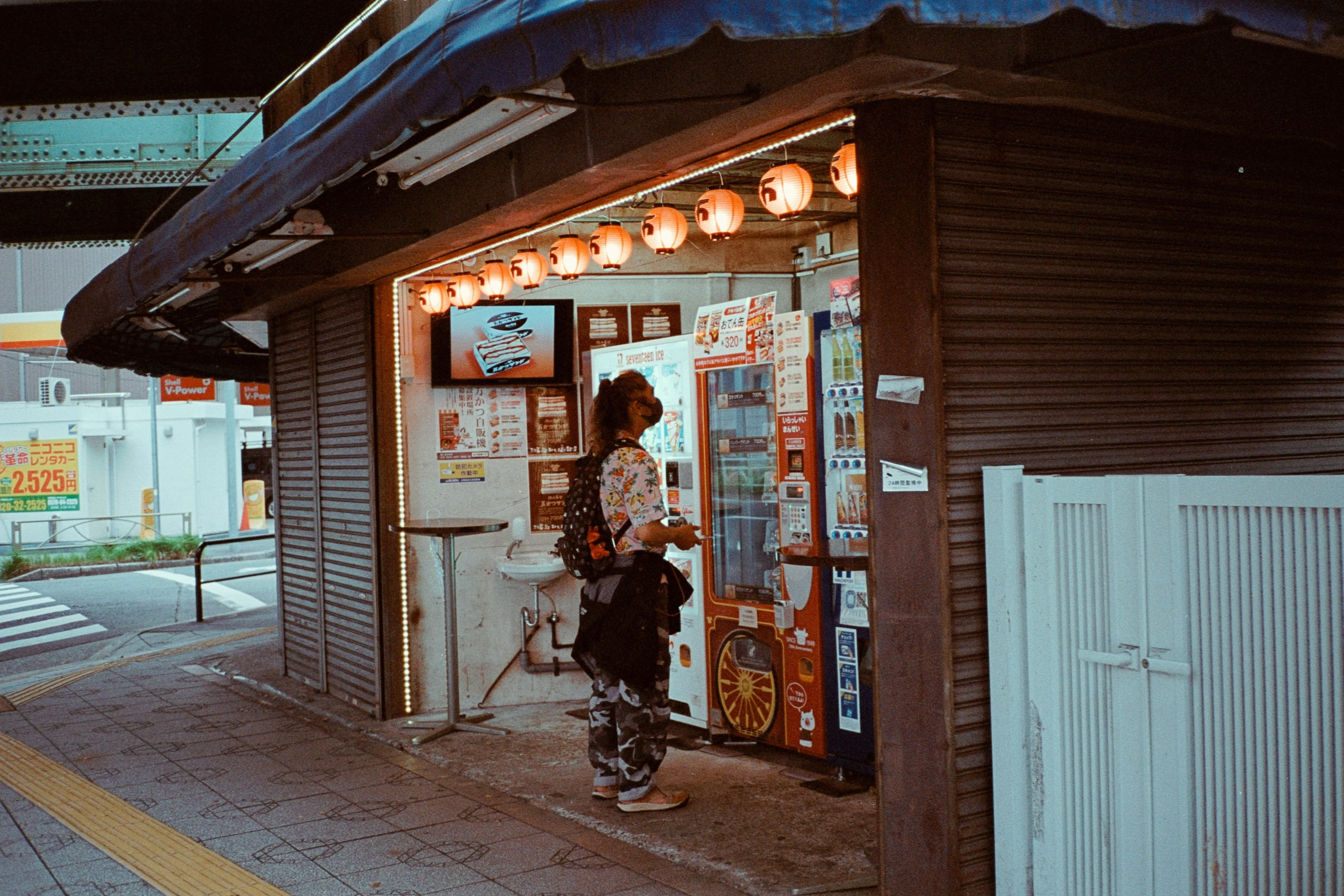 a man standing on a sidewalk in front of a store