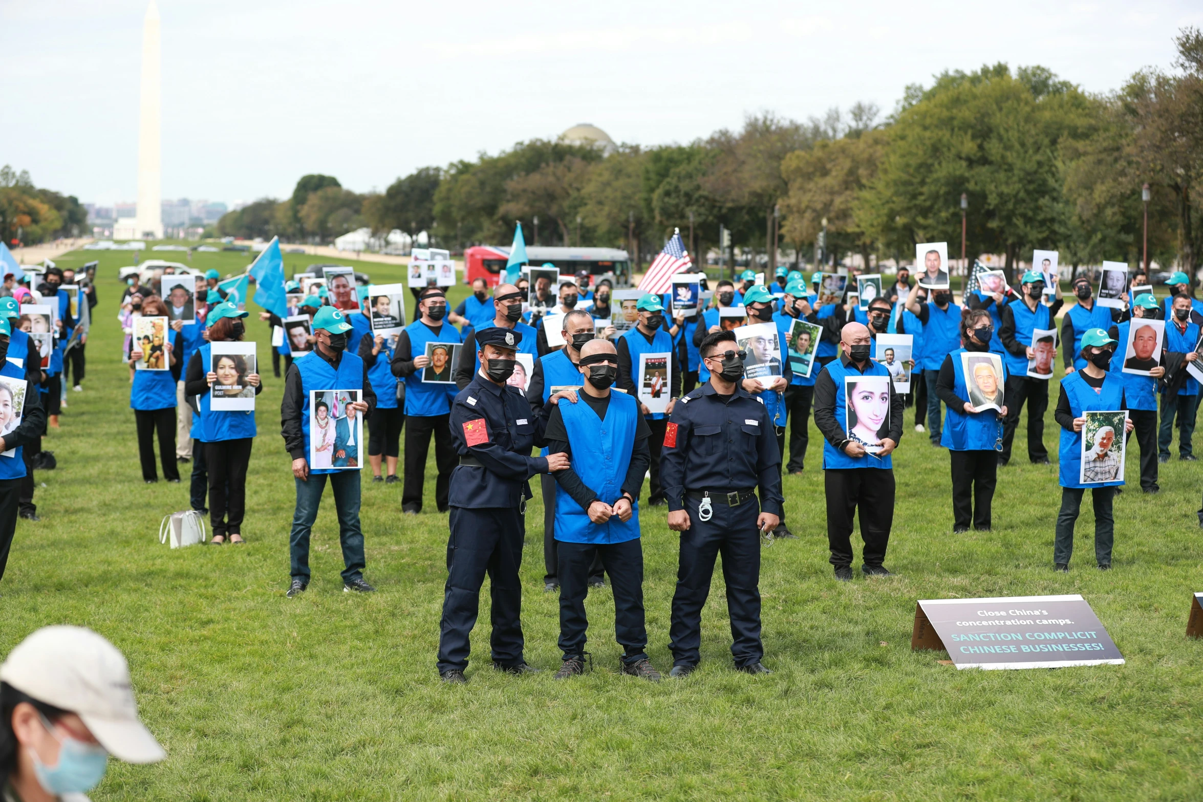 people in uniforms holding signs in the middle of the grass