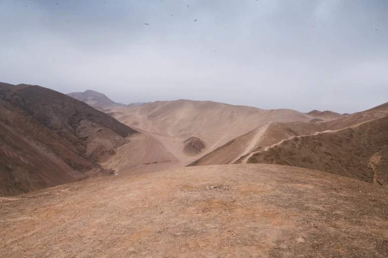 a mountain range covered with barren patches and mountains