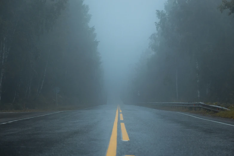 the road is empty in a very foggy weather