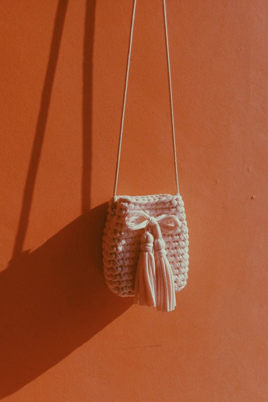 a bag is hanging on a wall against the wall