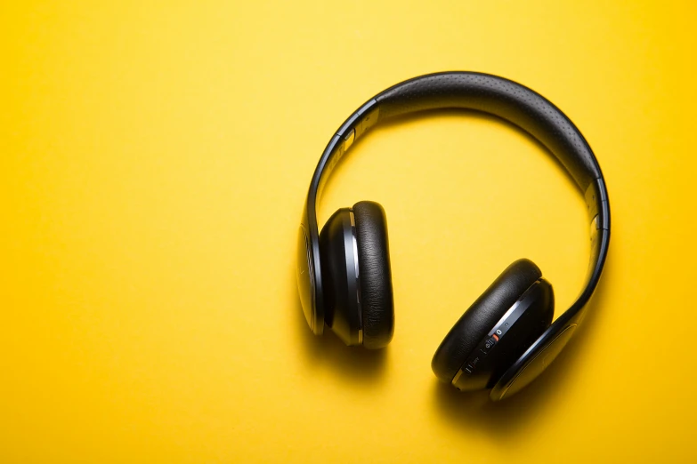 headphones on a yellow surface