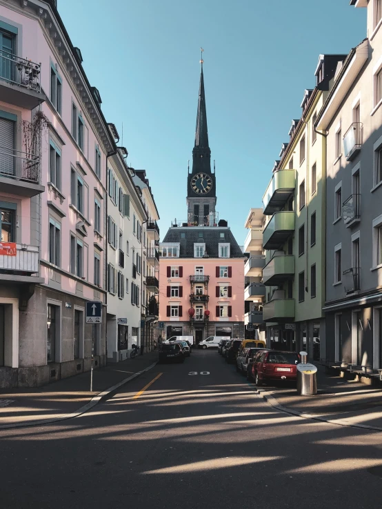 cars driving in a city road near buildings