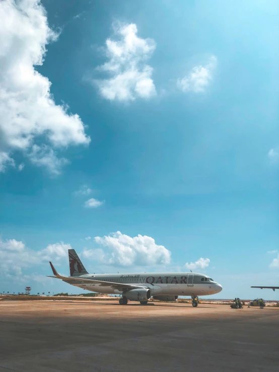 some large white airplanes parked on the runway