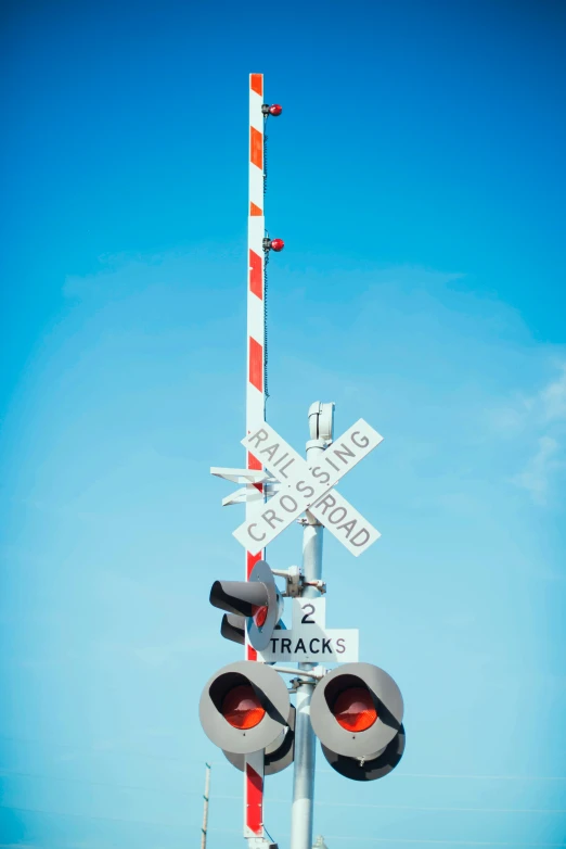 two traffic signals next to a road sign