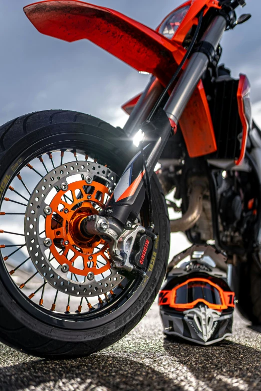 an orange motorcycle tire and an orange helmet