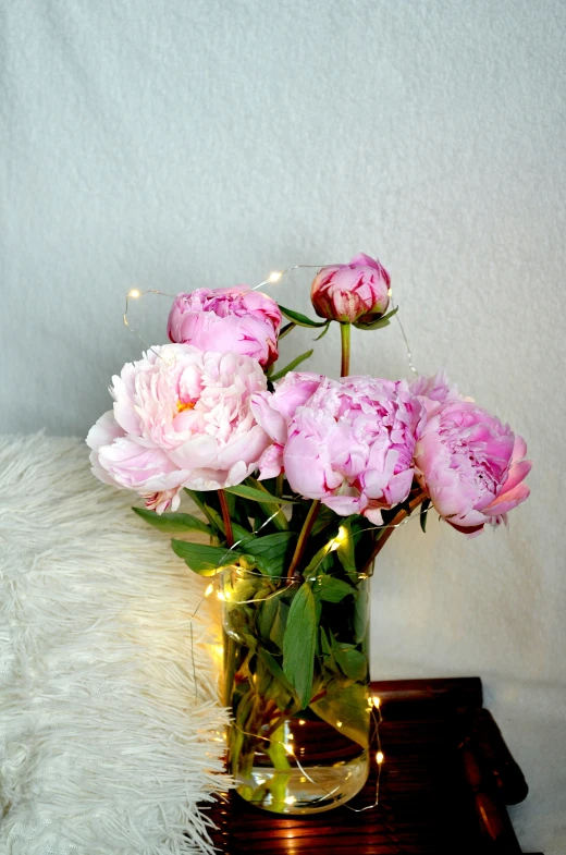 pink roses in a vase on a small table