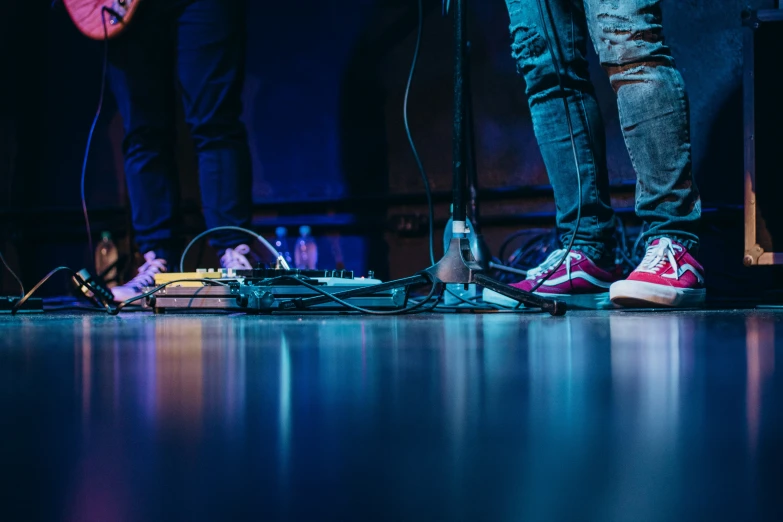 several people standing on stage with their feet apart