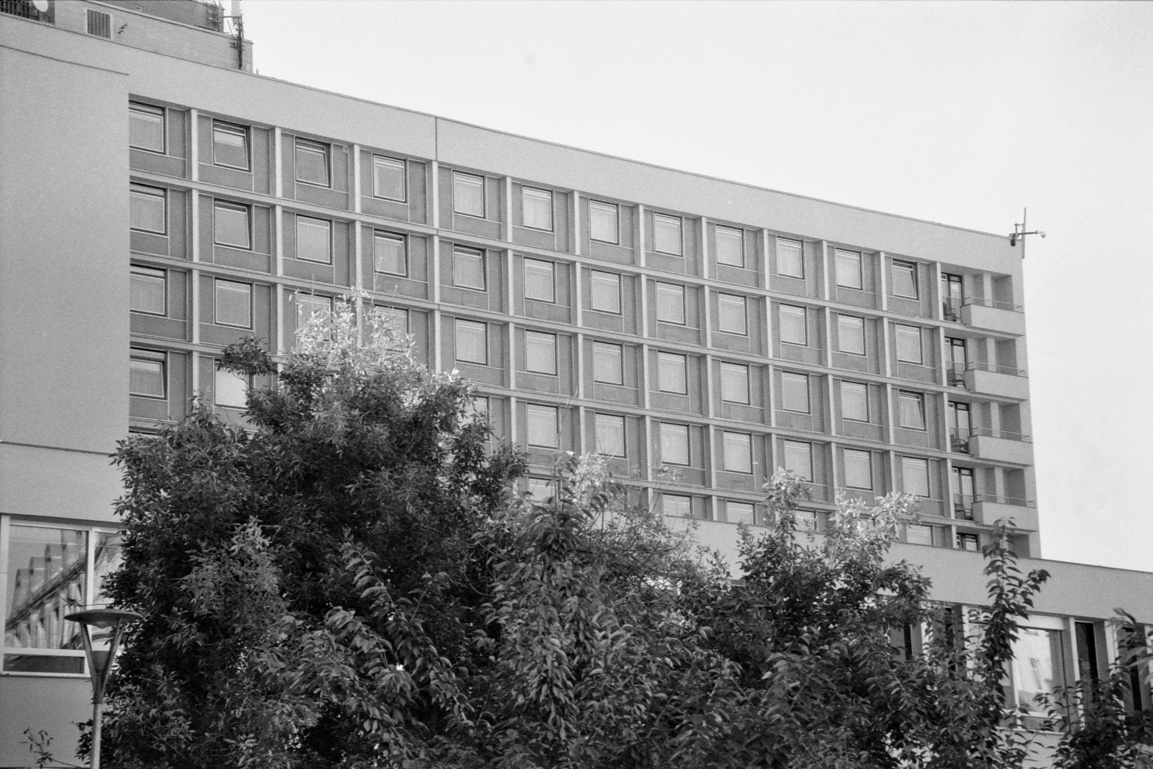 a large building is on the corner of the street