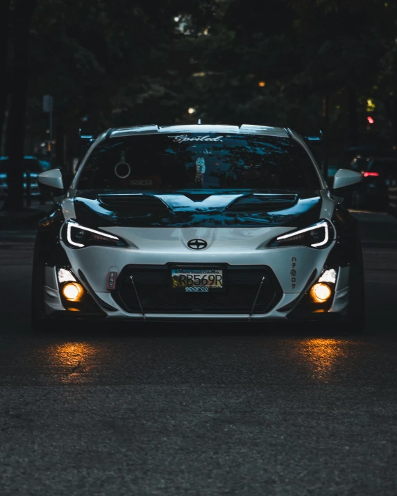 a toyota sports car driving down the street