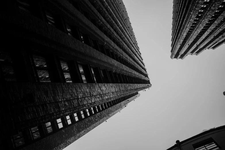 looking up at tall buildings against the sky