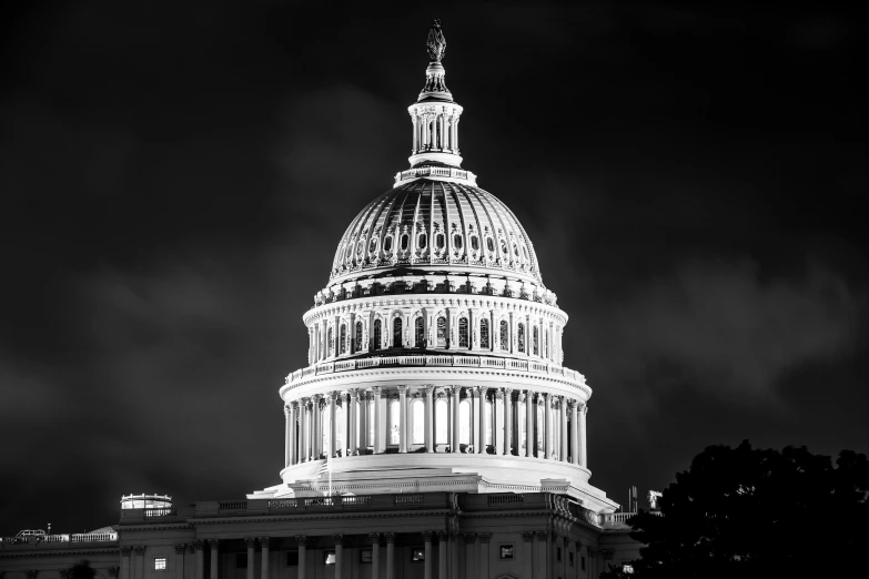 black and white pograph of the capitol building at night