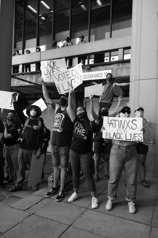 a group of people holding up protest signs