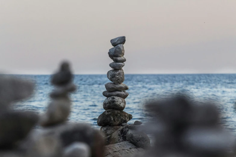 a pile of rocks sitting on top of a beach