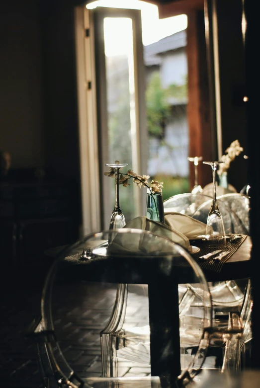 the view of a dining room table and chairs from outside