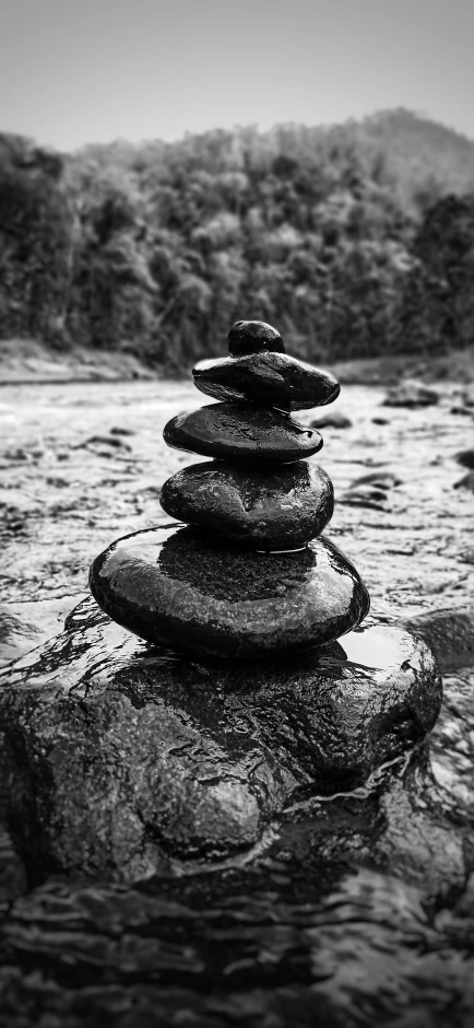 stacked rocks with forest in the background