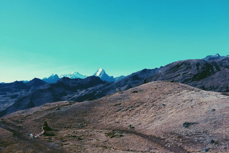 a man on a bike riding down the side of a mountain