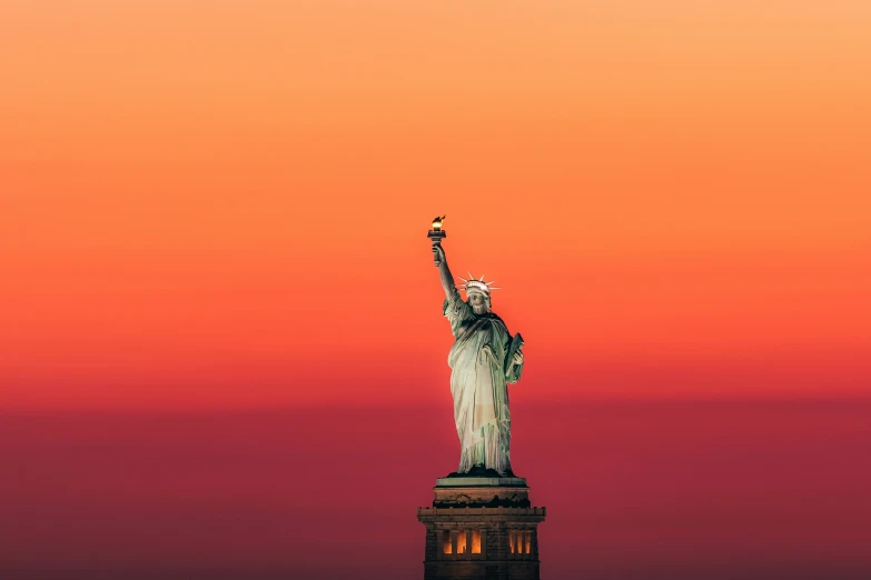 the statue of liberty as the sun is setting