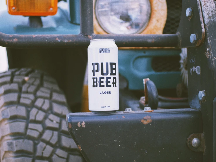 beer can with pub beer on the bumper of an old jeep