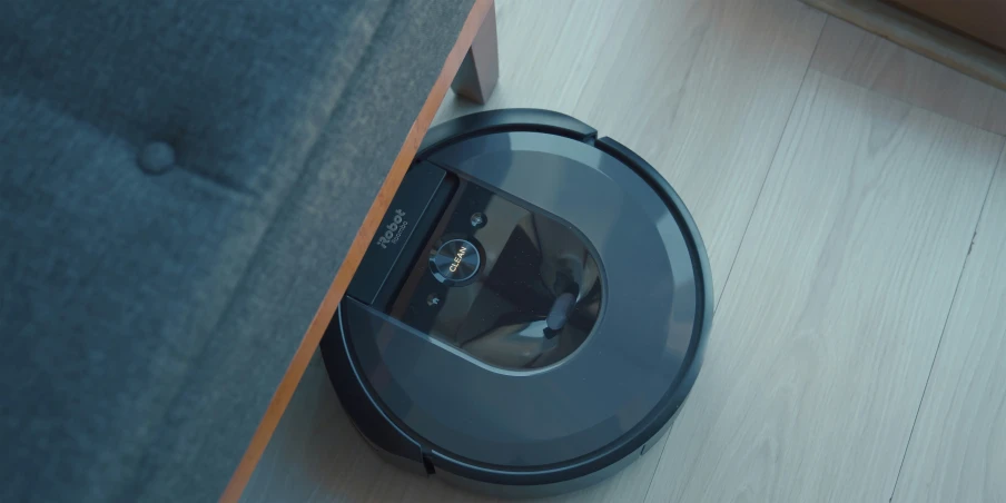 a robotic vacuum and other electronic devices on a wooden floor