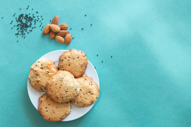 a white plate topped with cookies next to a pile of sea salt