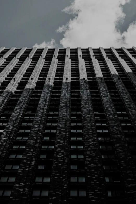 a high building that is standing in front of a cloudy sky