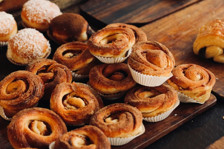 a table topped with a pile of pastry next to a basket