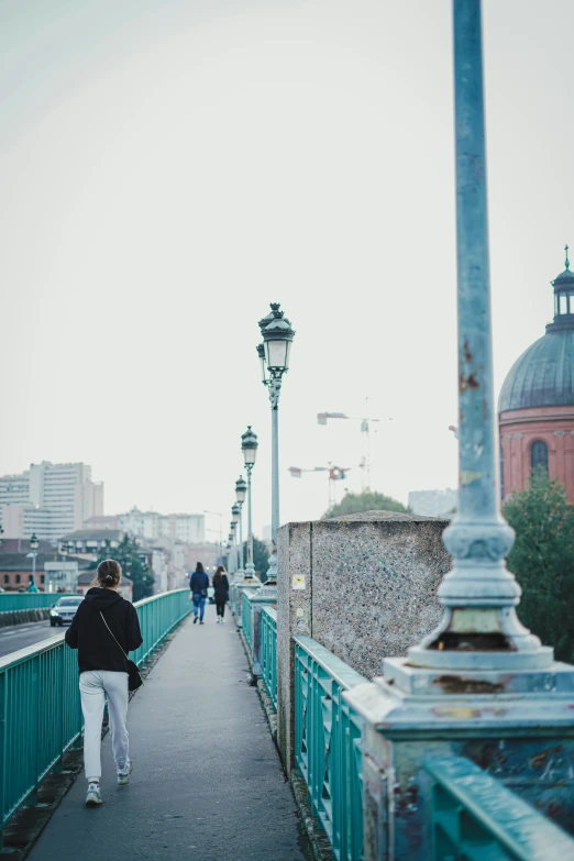 two men walking on the boardwalk on a bridge