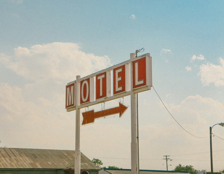 an older style el with a big sign on the street