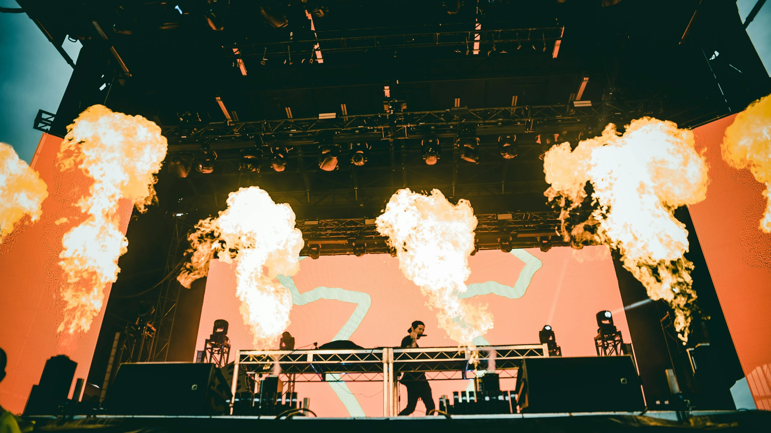 an image of a concert setting with smoke being lit up