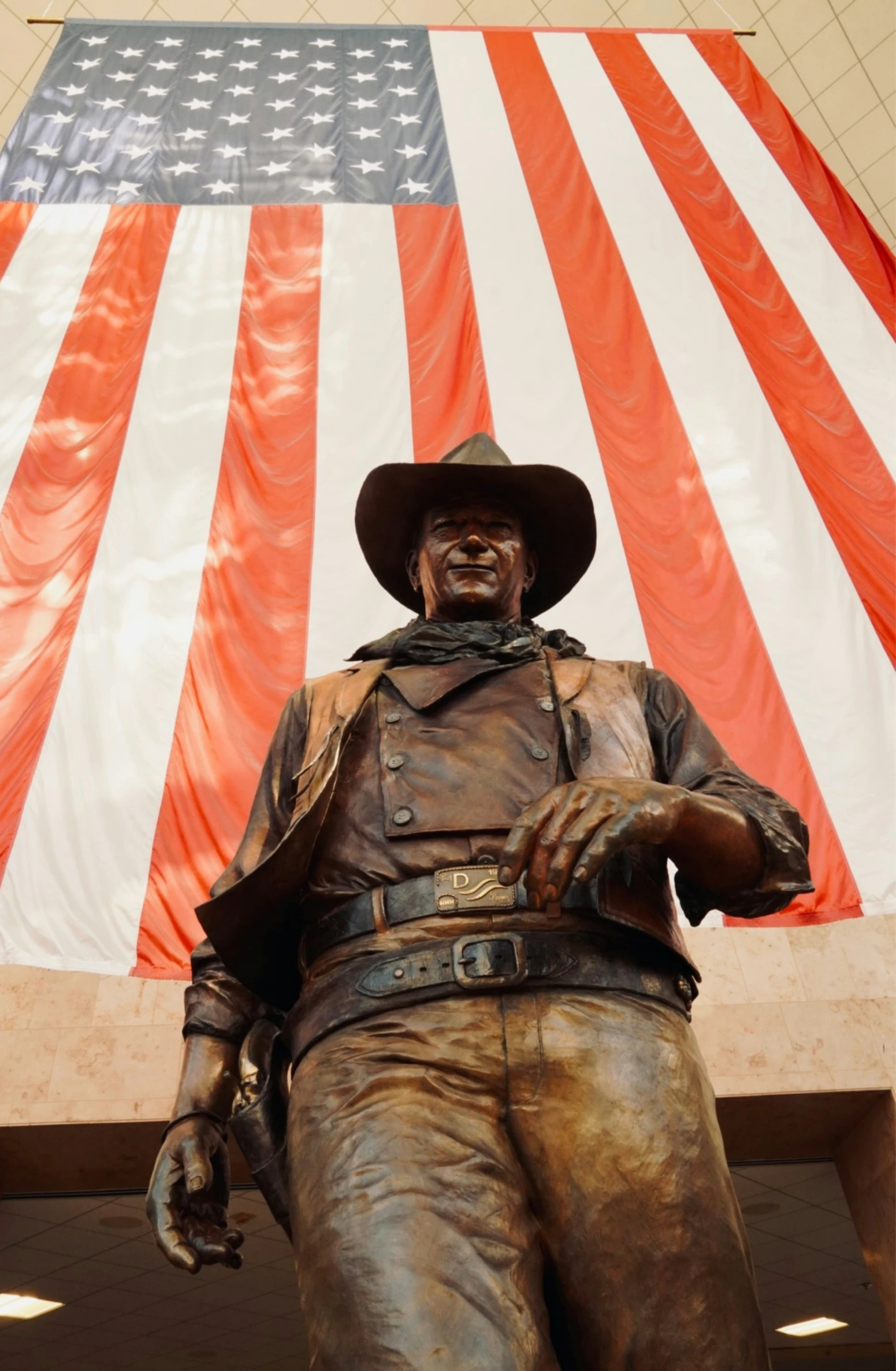 a statue in front of an american flag