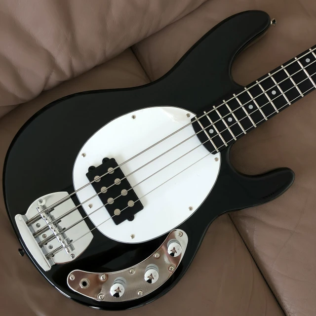 a black and white guitar with a black neck