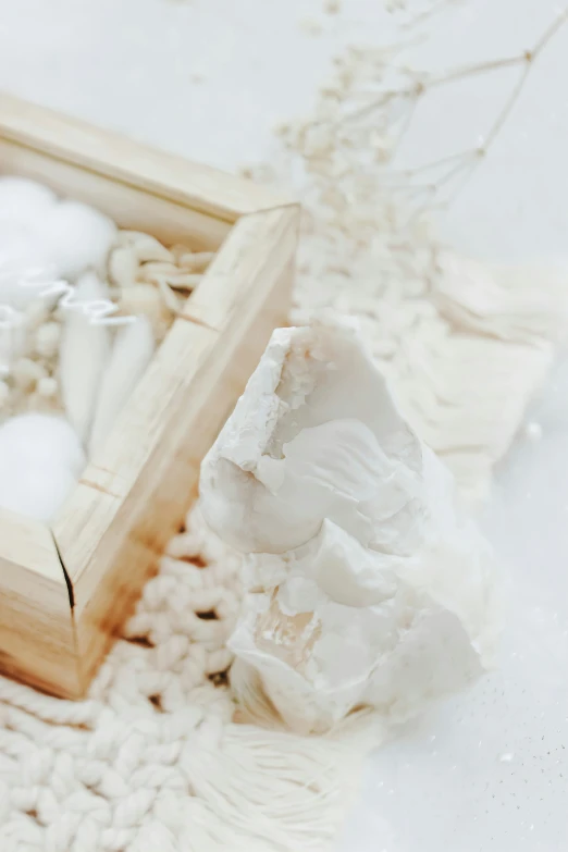 a white rock is on the floor in a wood frame