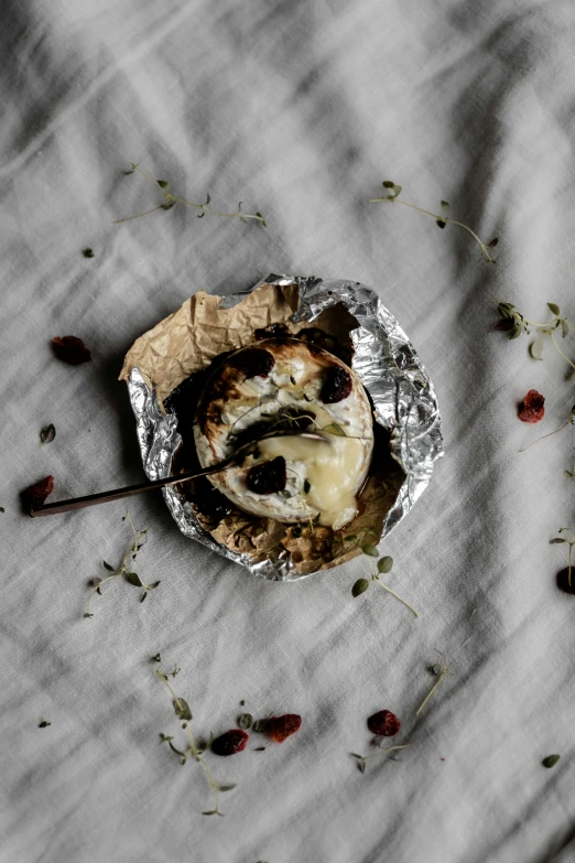 a peeled cupcake sitting in foil on a table