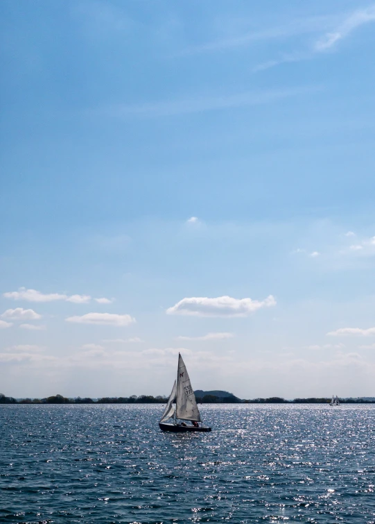 a sailboat is seen in the distance on a sunny day