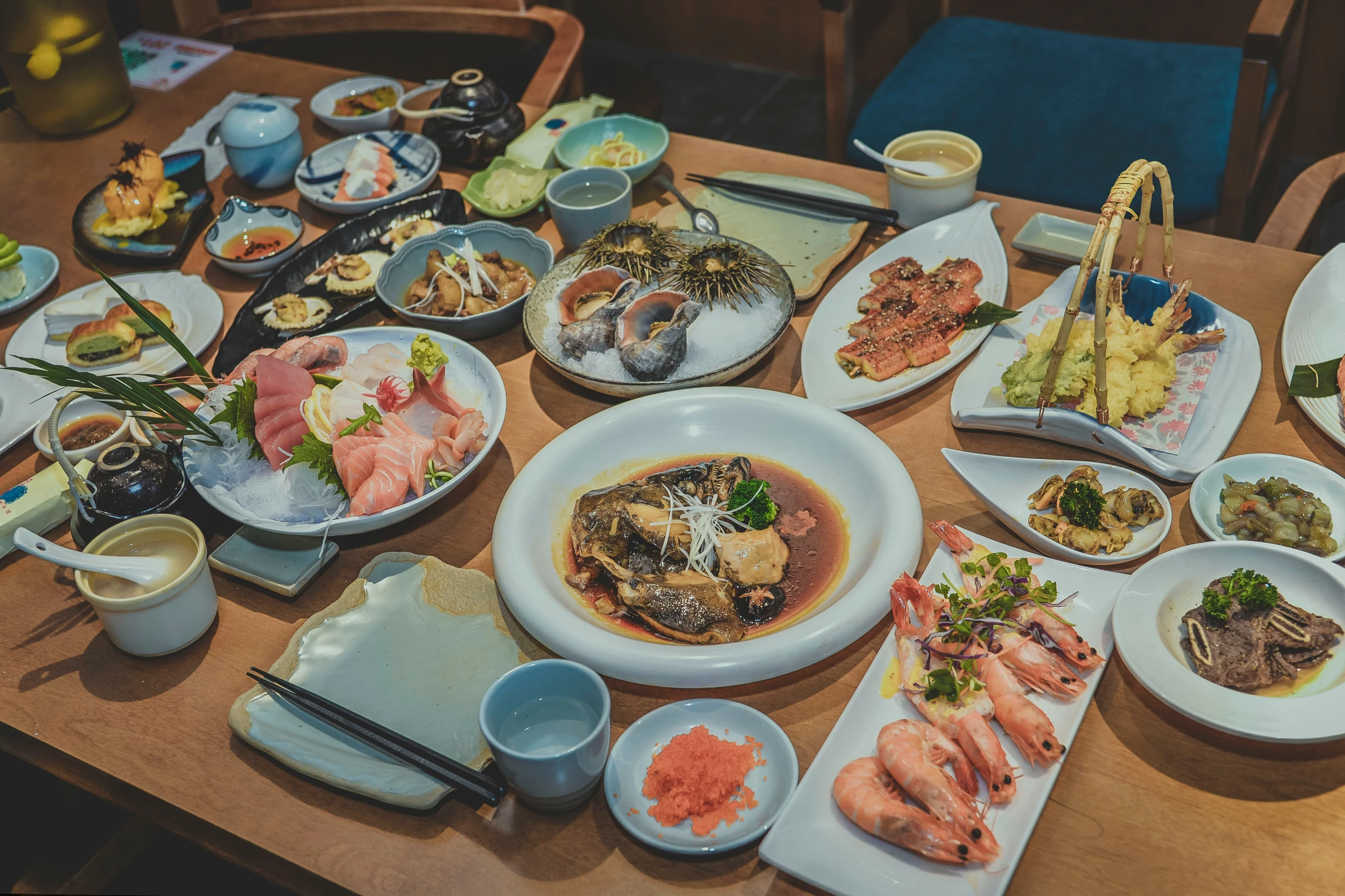 a dining table with an array of seafoods and other meats